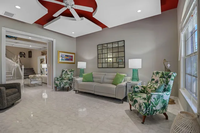 a living room with furniture and a clock