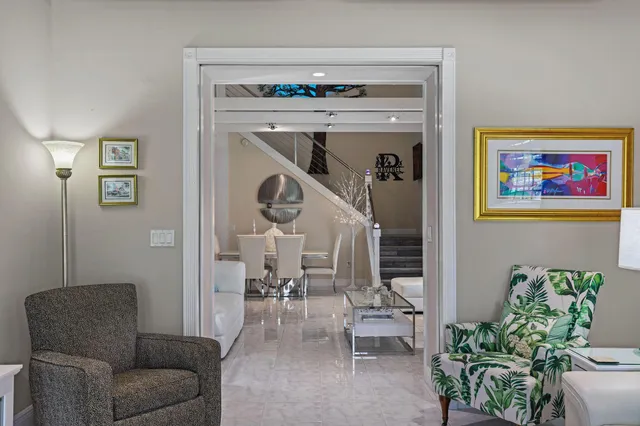 a living room with furniture and a chandelier
