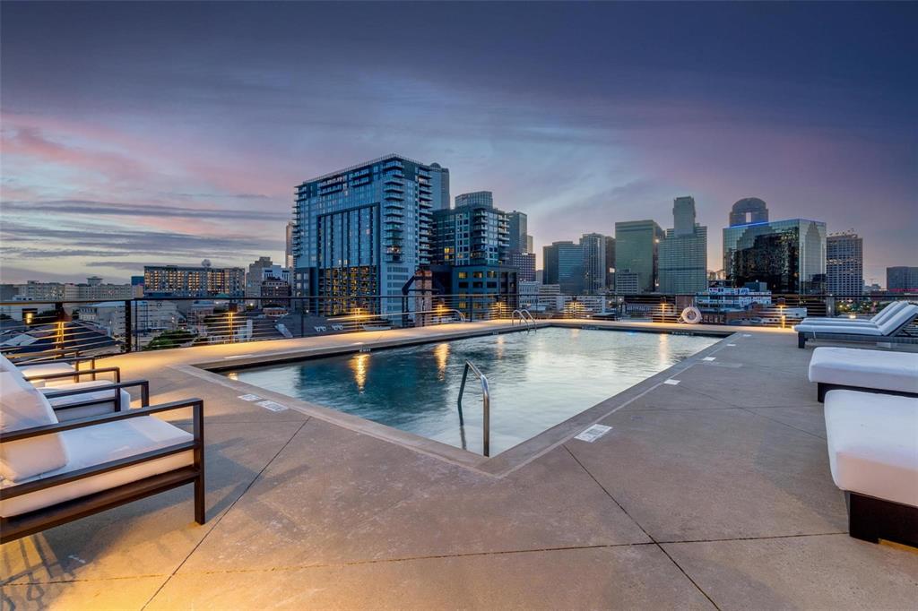 2220 Canton Street, Unit 101 Dallas, TX 75201 - Photo 17 of 20 Rooftop pool with concrete decking, perimeter lighting, and metal safety railing