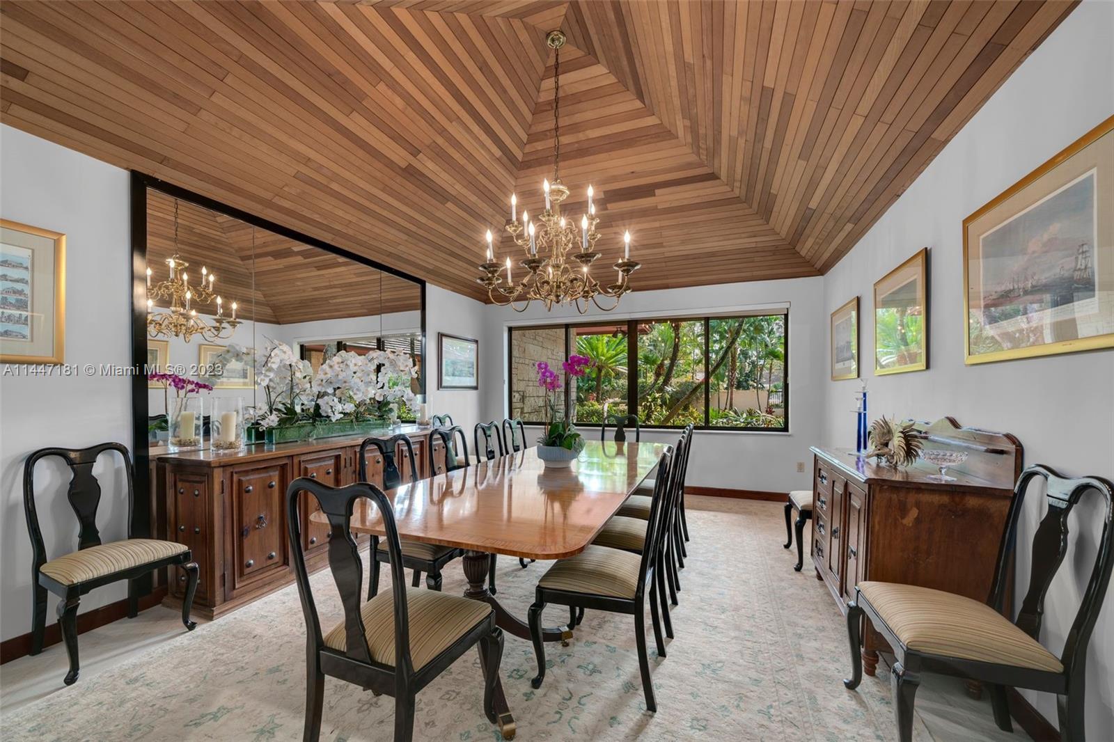 4875 Southwest 80th Street Miami, FL 33143 - Photo 12 of 52 a view of a dining room with furniture a chandelier and window
