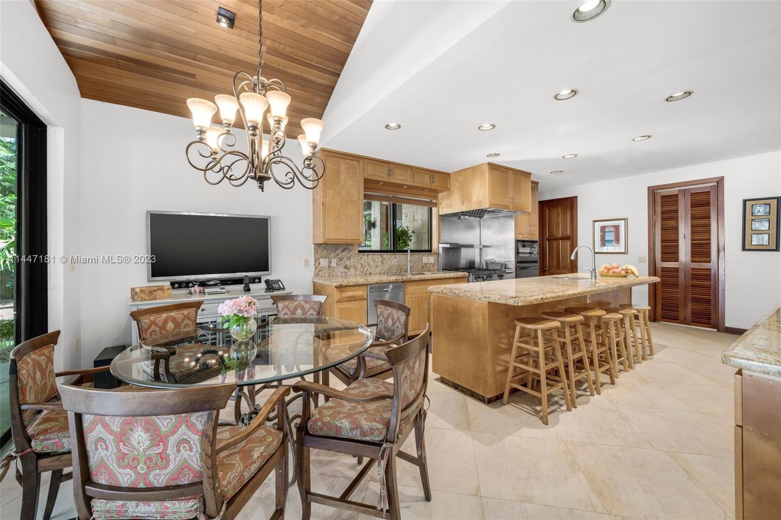 4875 Southwest 80th Street Miami, FL 33143 - Photo 15 of 52 a view of a dining room with furniture wooden floor and chandelier