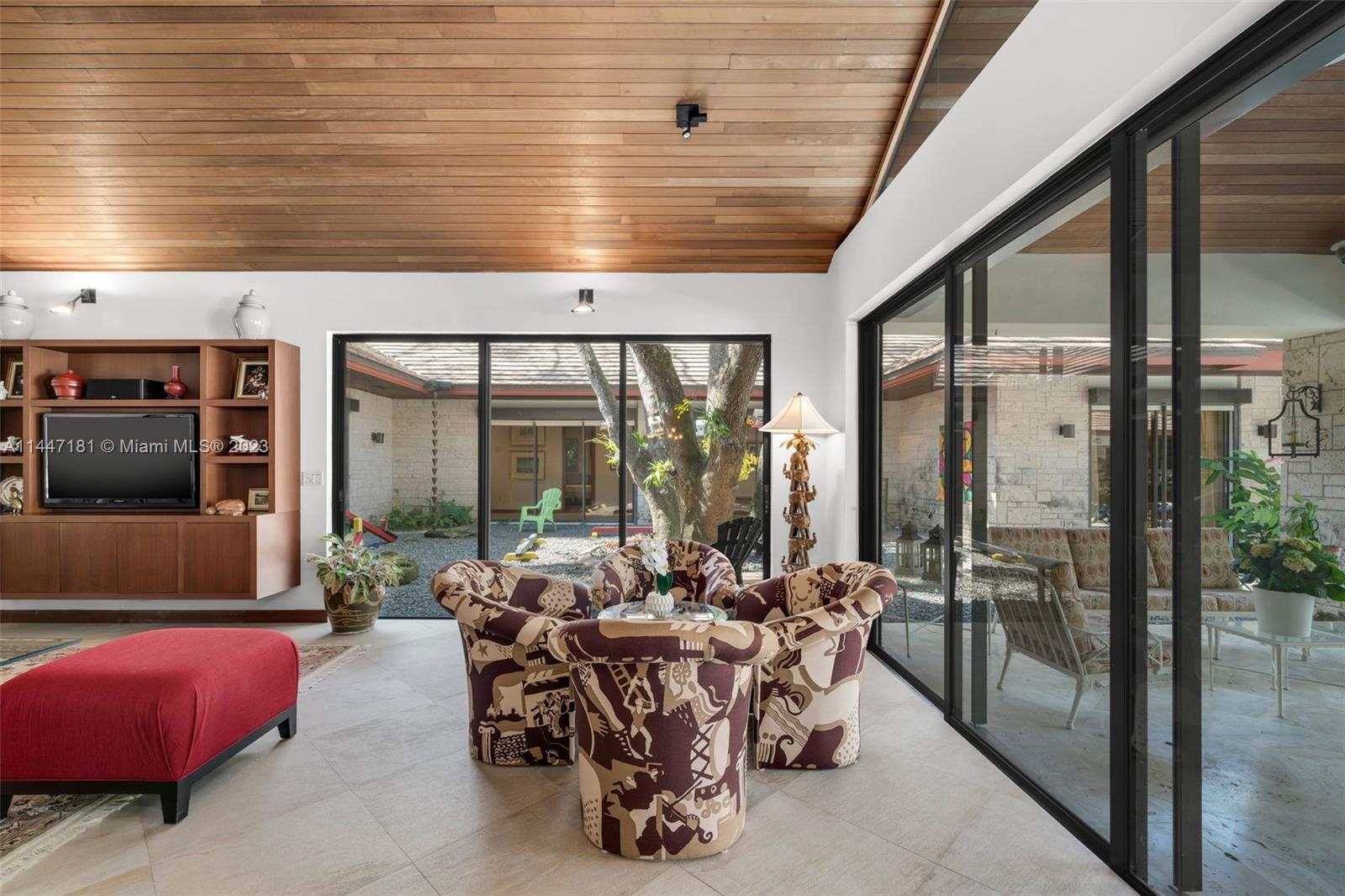 4875 Southwest 80th Street Miami, FL 33143 - Photo 18 of 52 a living room with furniture and a flat screen tv