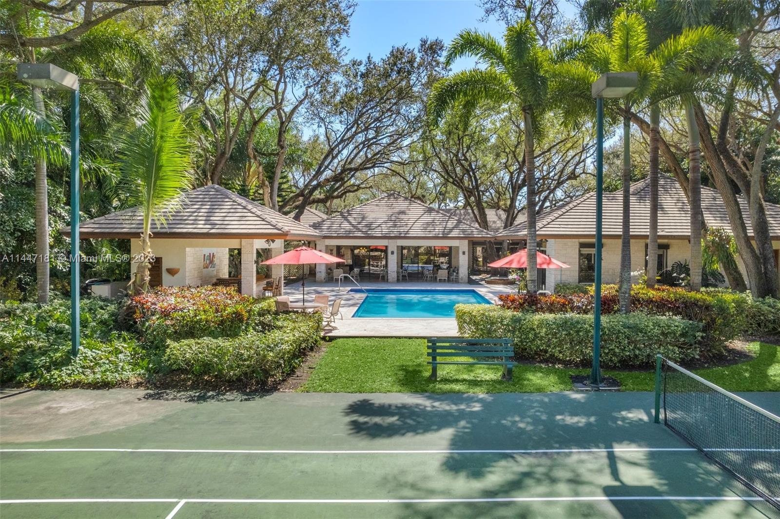 4875 Southwest 80th Street Miami, FL 33143 - Photo 2 of 52 a front view of house with yard and green space