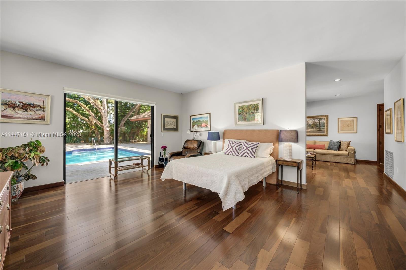 4875 Southwest 80th Street Miami, FL 33143 - Photo 22 of 52 a spacious bedroom with a bed and wooden floor