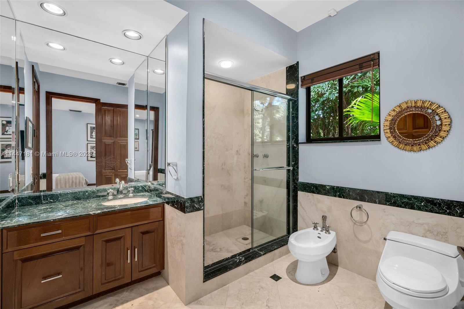 4875 Southwest 80th Street Miami, FL 33143 - Photo 28 of 52 a bathroom with a toilet sink and mirror