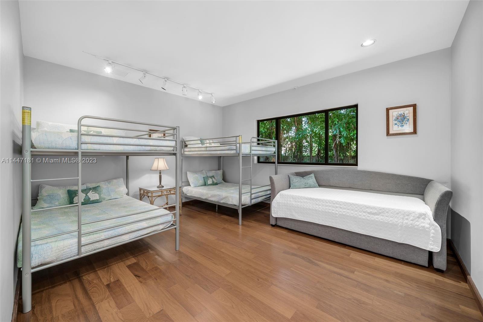 4875 Southwest 80th Street Miami, FL 33143 - Photo 29 of 52 a bedroom with a bed and large window