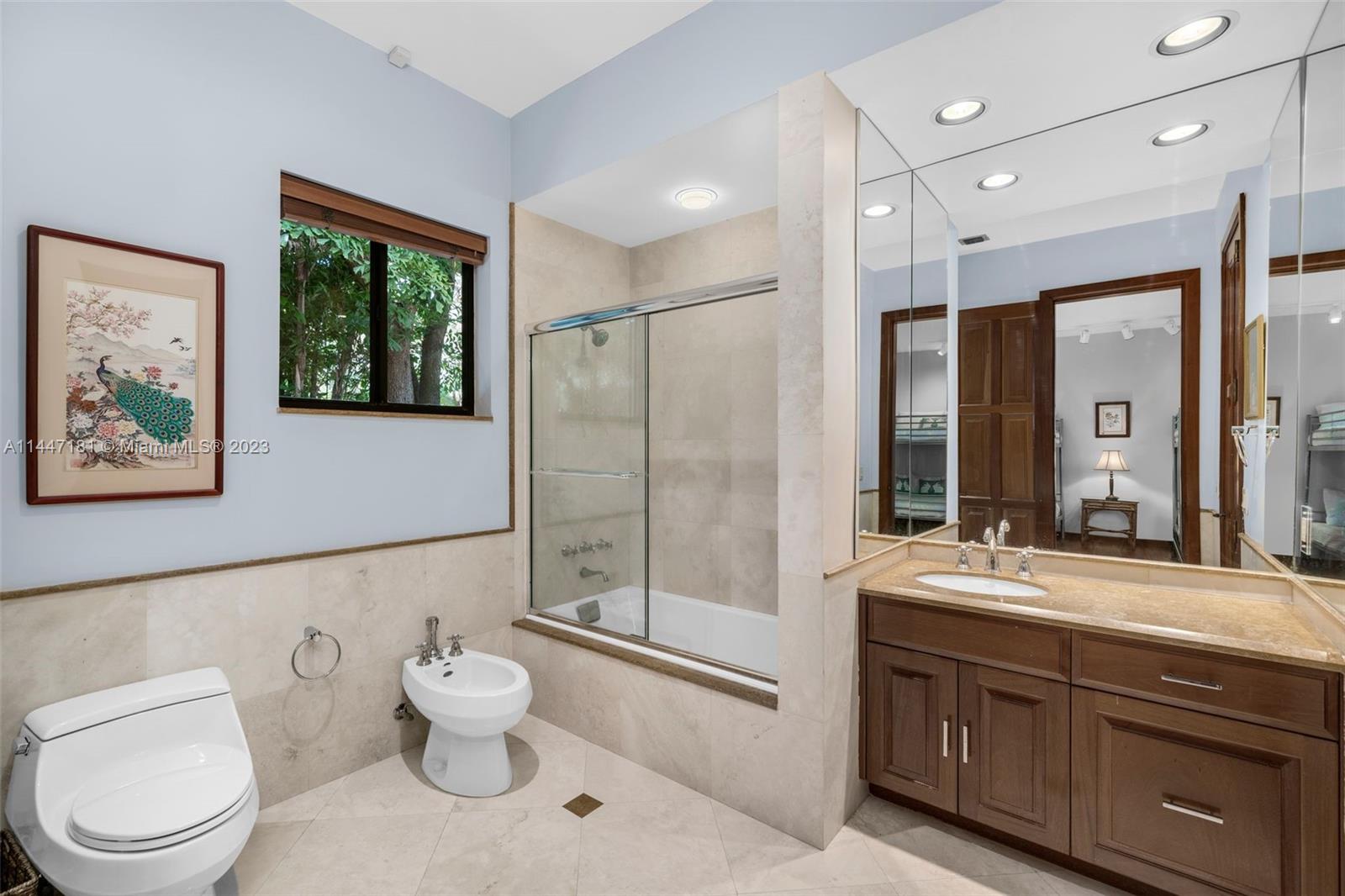 4875 Southwest 80th Street Miami, FL 33143 - Photo 30 of 52 a bathroom with a toilet sink double vanity and mirror