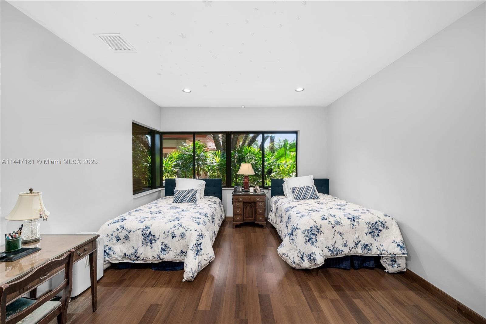 4875 Southwest 80th Street Miami, FL 33143 - Photo 31 of 52 a bedroom with two beds and large windows