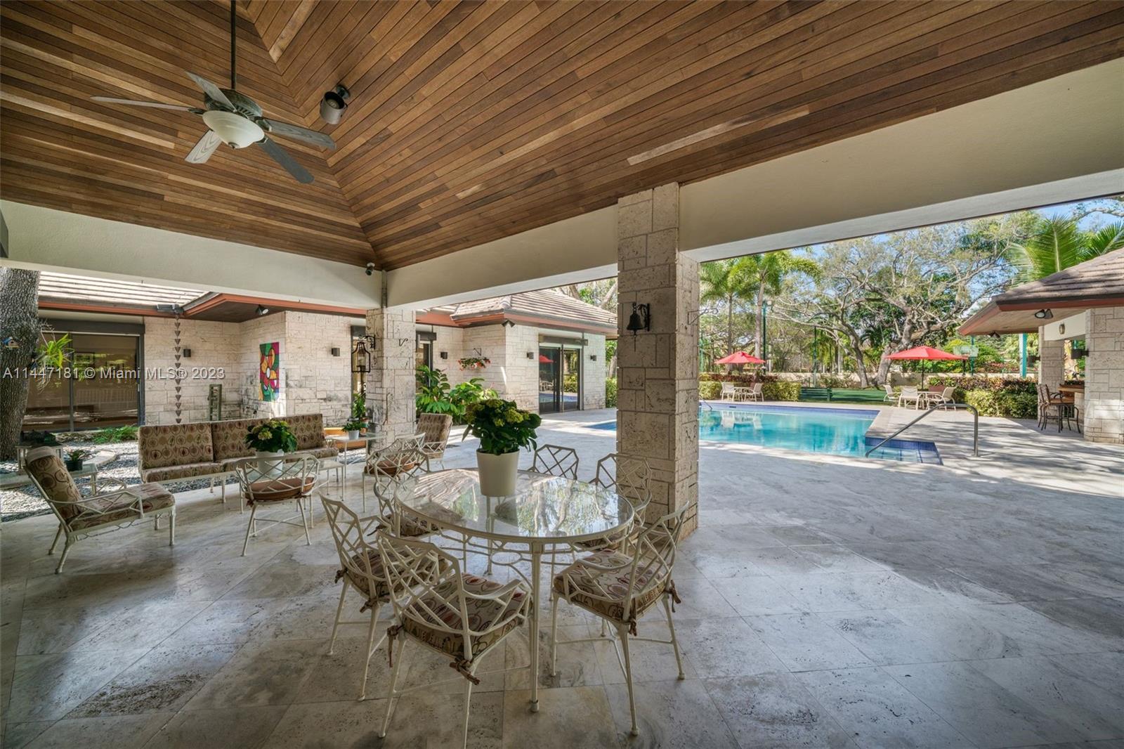 4875 Southwest 80th Street Miami, FL 33143 - Photo 35 of 52 a view of a patio with table and chairs and potted plants