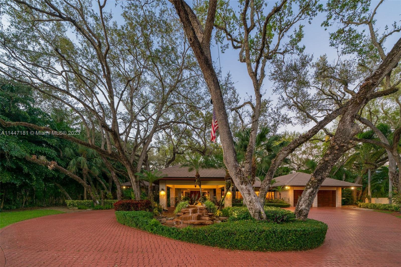 4875 Southwest 80th Street Miami, FL 33143 - Photo 43 of 52 a front view of a house with a yard and shrubs
