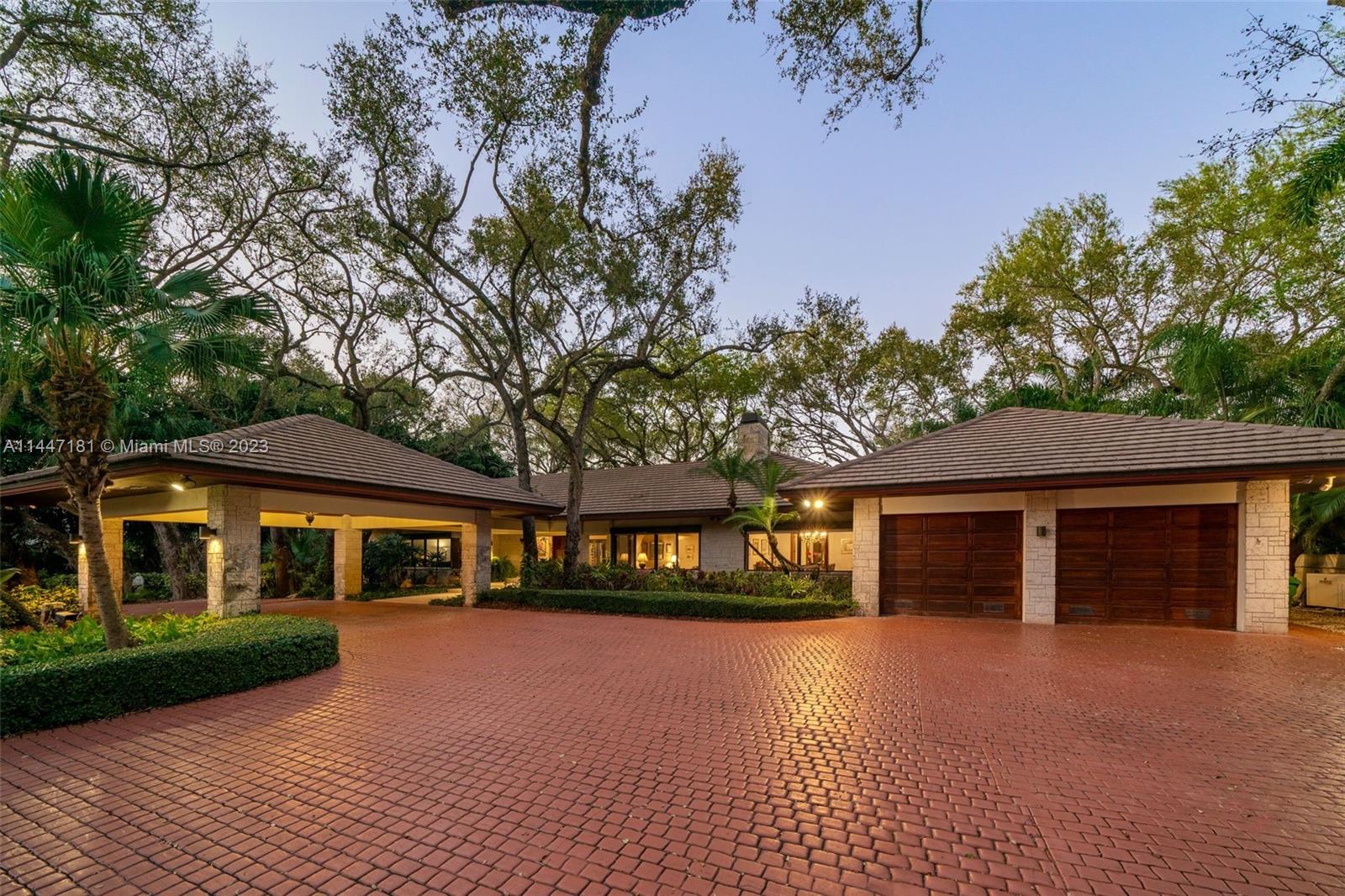 4875 Southwest 80th Street Miami, FL 33143 - Photo 44 of 52 a front view of a house with a yard