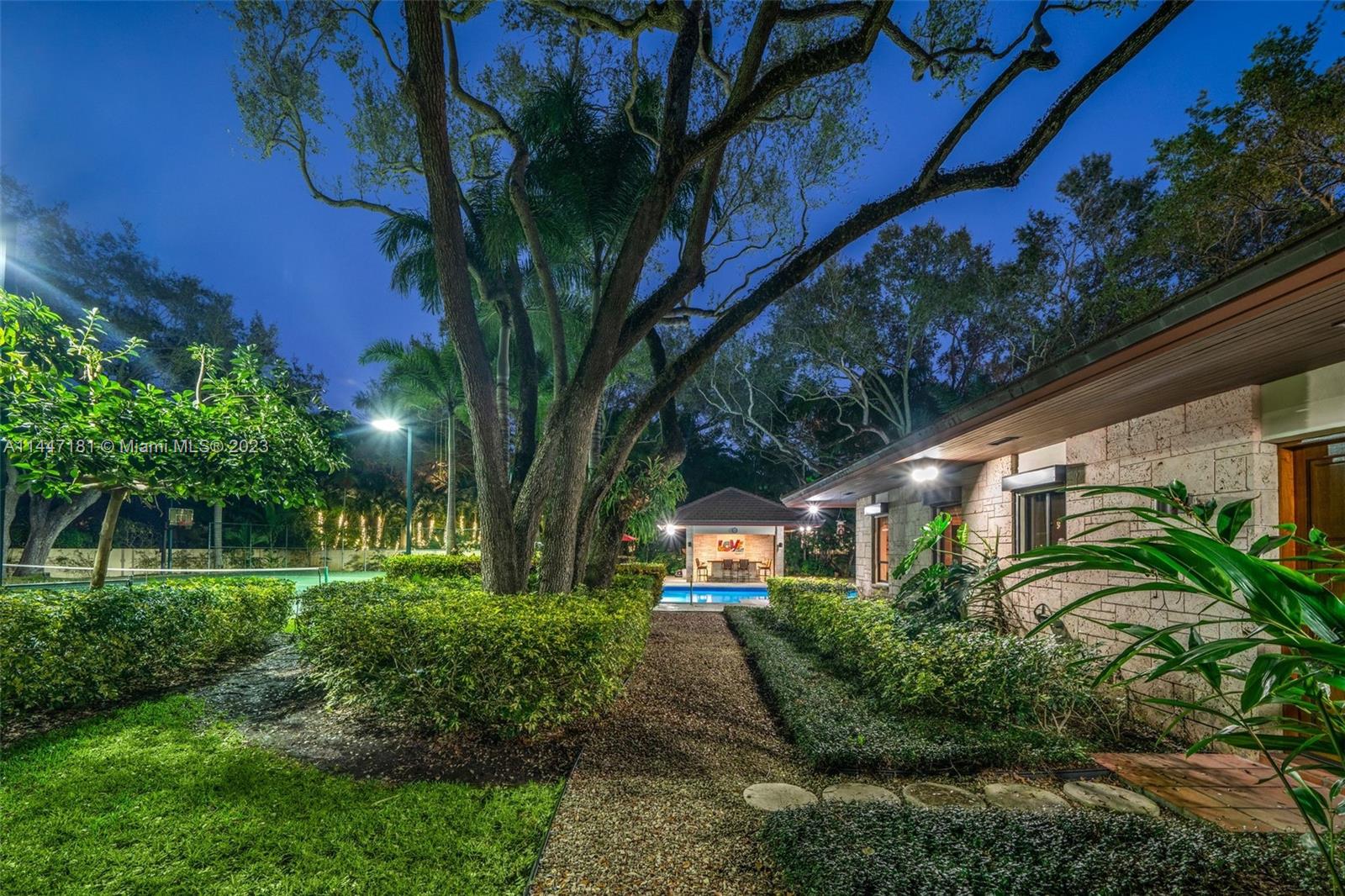 4875 Southwest 80th Street Miami, FL 33143 - Photo 50 of 52 a front view of a house with a yard