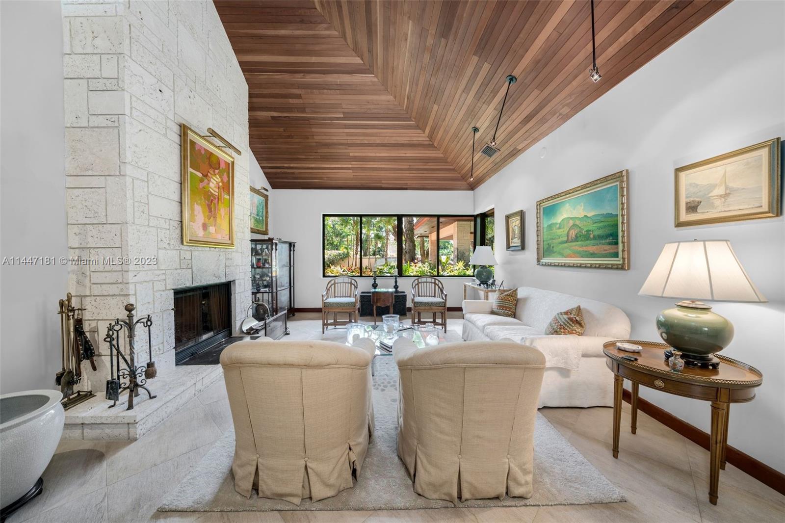 4875 Southwest 80th Street Miami, FL 33143 - Photo 7 of 52 a living room with fireplace furniture and a large window