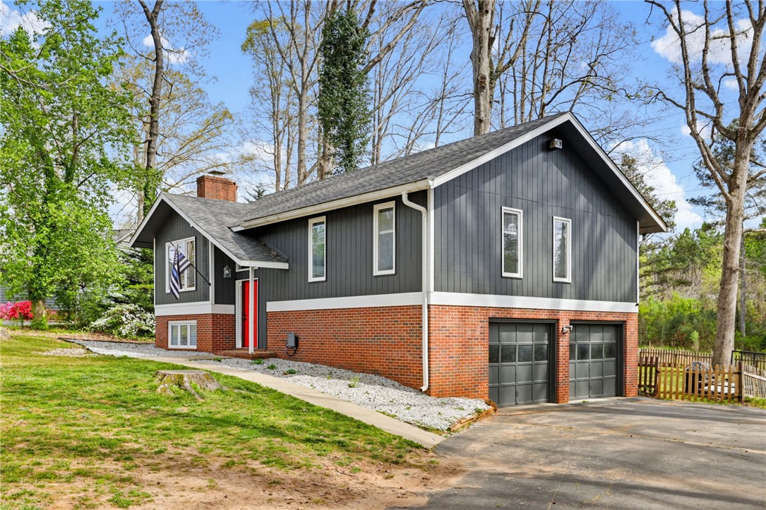 137 Towne Creek Trail Anderson, SC 29621 - Photo 2 of 23 This charming home features a striking brick and wood exterior, offering both curb appeal and durability.