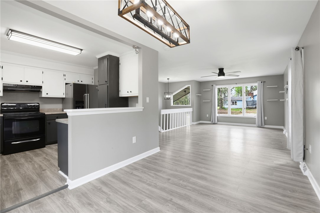 137 Towne Creek Trail Anderson, SC 29621 - Photo 6 of 23 This bright interior features an open-concept living area with a kitchen, offering an inviting atmosphere.