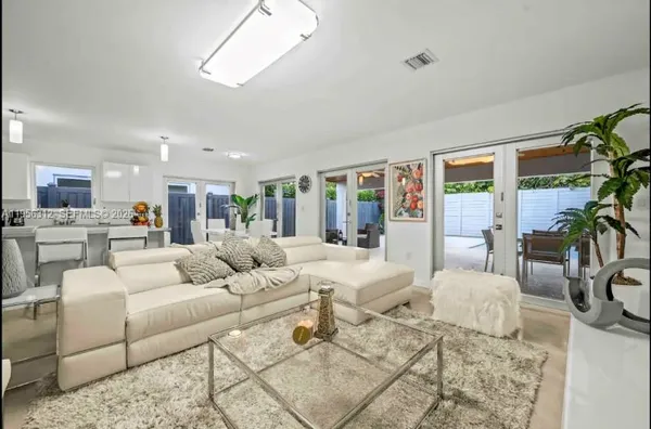a living room with fireplace furniture and a large window