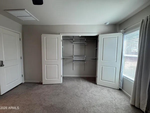 a bathroom with a granite countertop sink a toilet a shower and a mirror