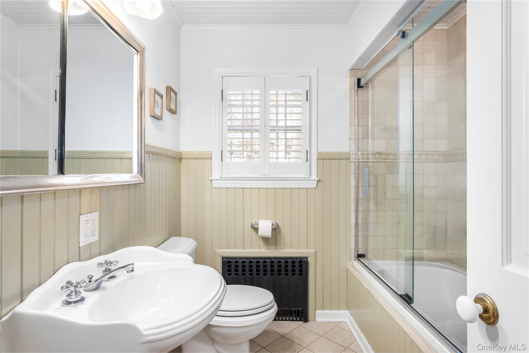 56 Seaman Road Riverhead, NY 11901 - Photo 5 of 9 a bathroom with a toilet a sink and a bathtub