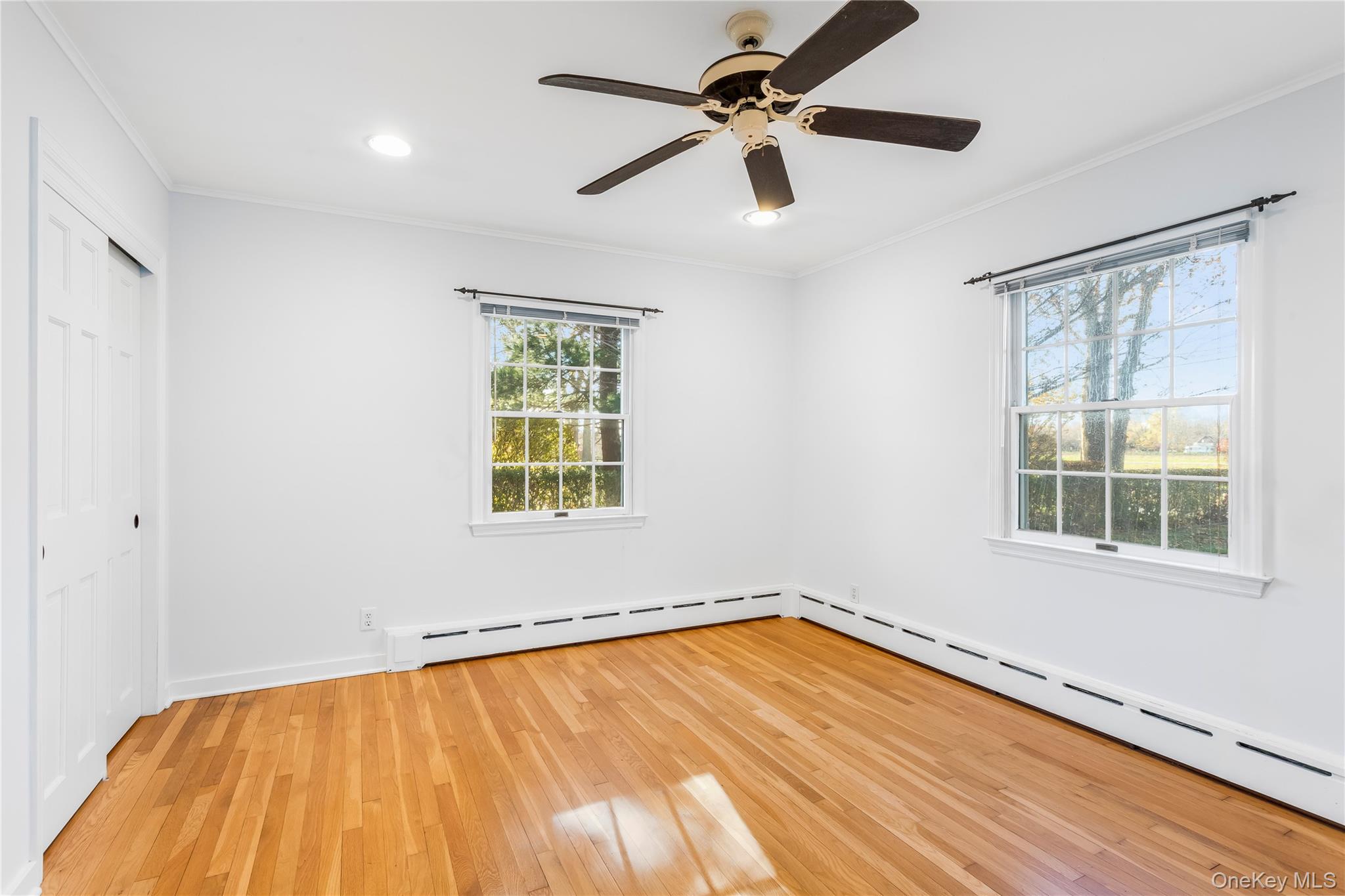 56 Seaman Road Riverhead, NY 11901 - Photo 7 of 9 wooden floor in an empty room with a window