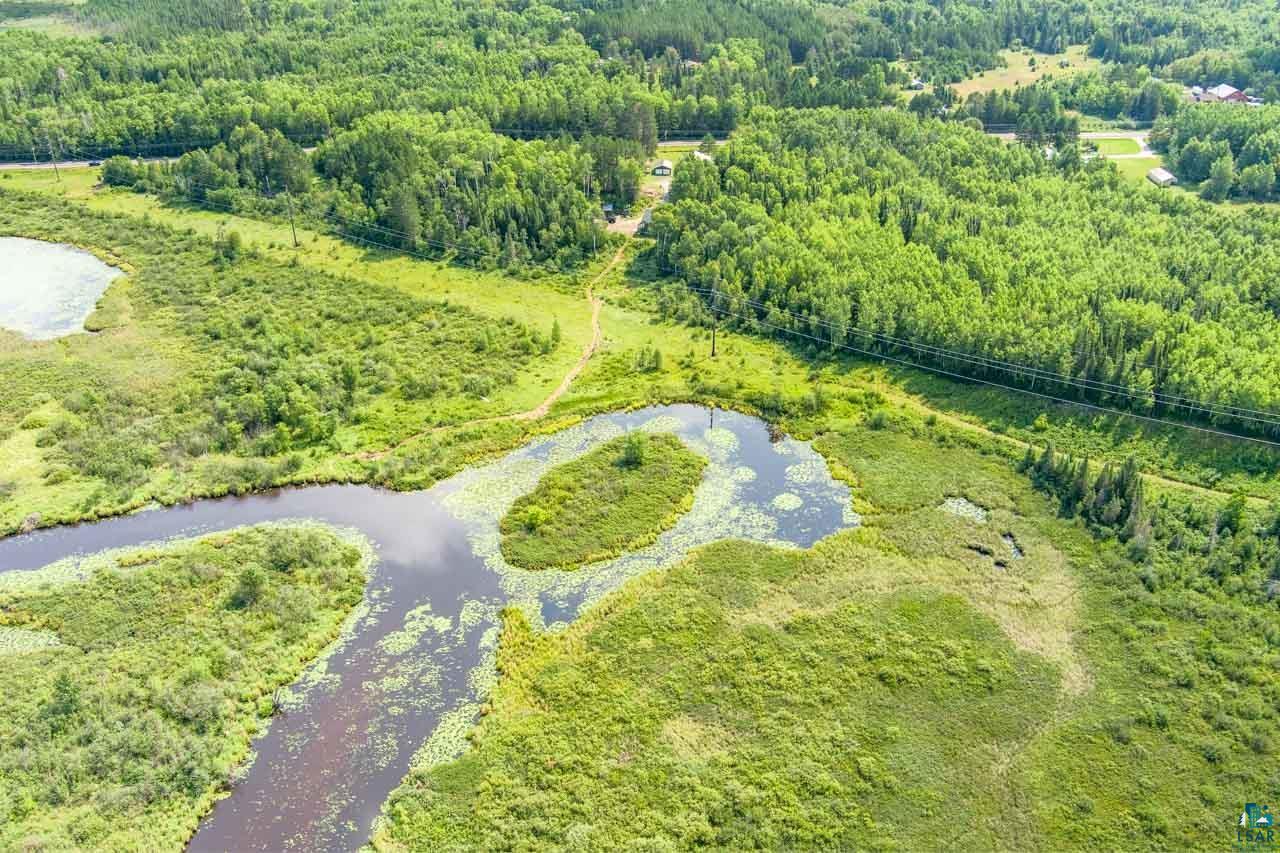 7603 Levander Road Embarrass, MN 55732 - Photo 49 of 51 Expansive natural landscape featuring wetlands, a winding waterway, and dense mature forest