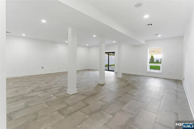 an empty room with windows and pillars in it