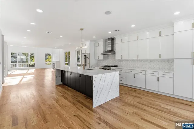 a large kitchen with stainless steel appliances granite countertop a large counter top and a stove