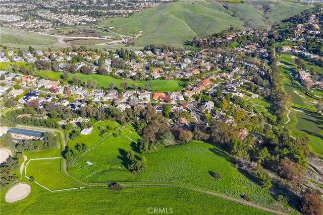 an aerial view of a golf course with parking