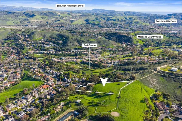 an aerial view of residential houses with outdoor space and swimming pool