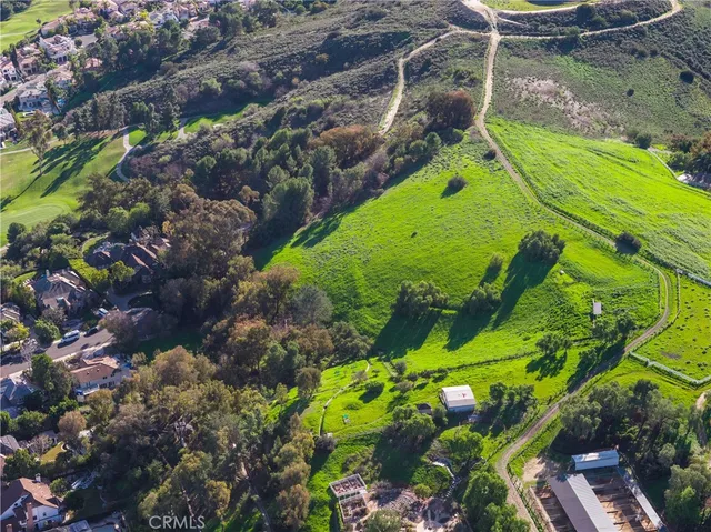 a view of a swimming pool with a yard and plants