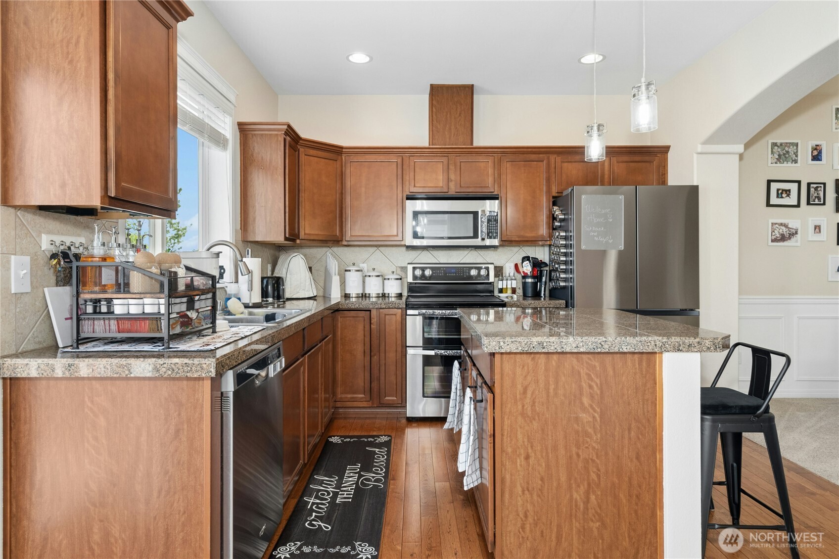 527 Pilchuck Path Everett, WA 98201 - Photo 12 of 38 a kitchen with stainless steel appliances granite countertop a refrigerator a stove top oven a sink and dishwasher