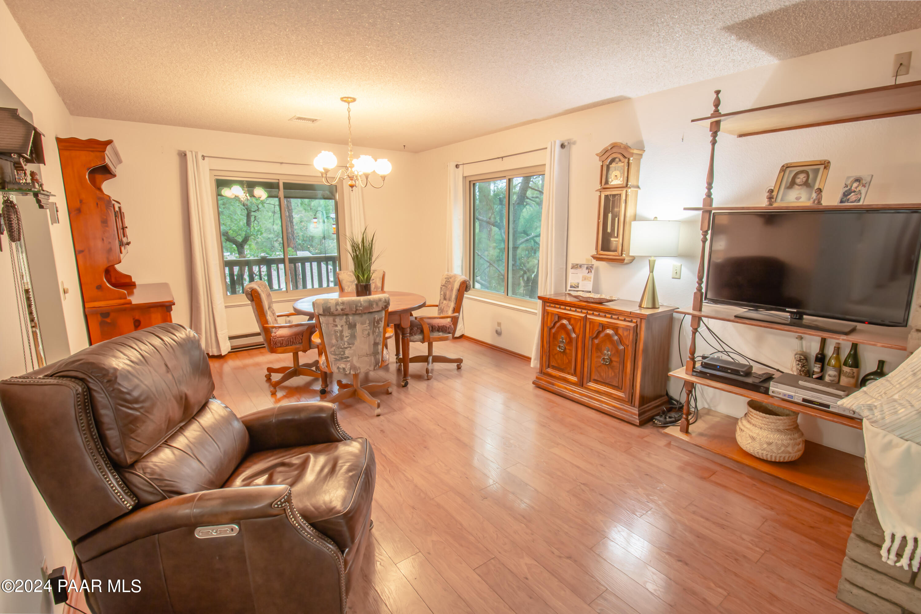 481 Turtleback Road Prescott, AZ 86303 - Photo 13 of 71 a living room with furniture a flat screen tv and wooden floor