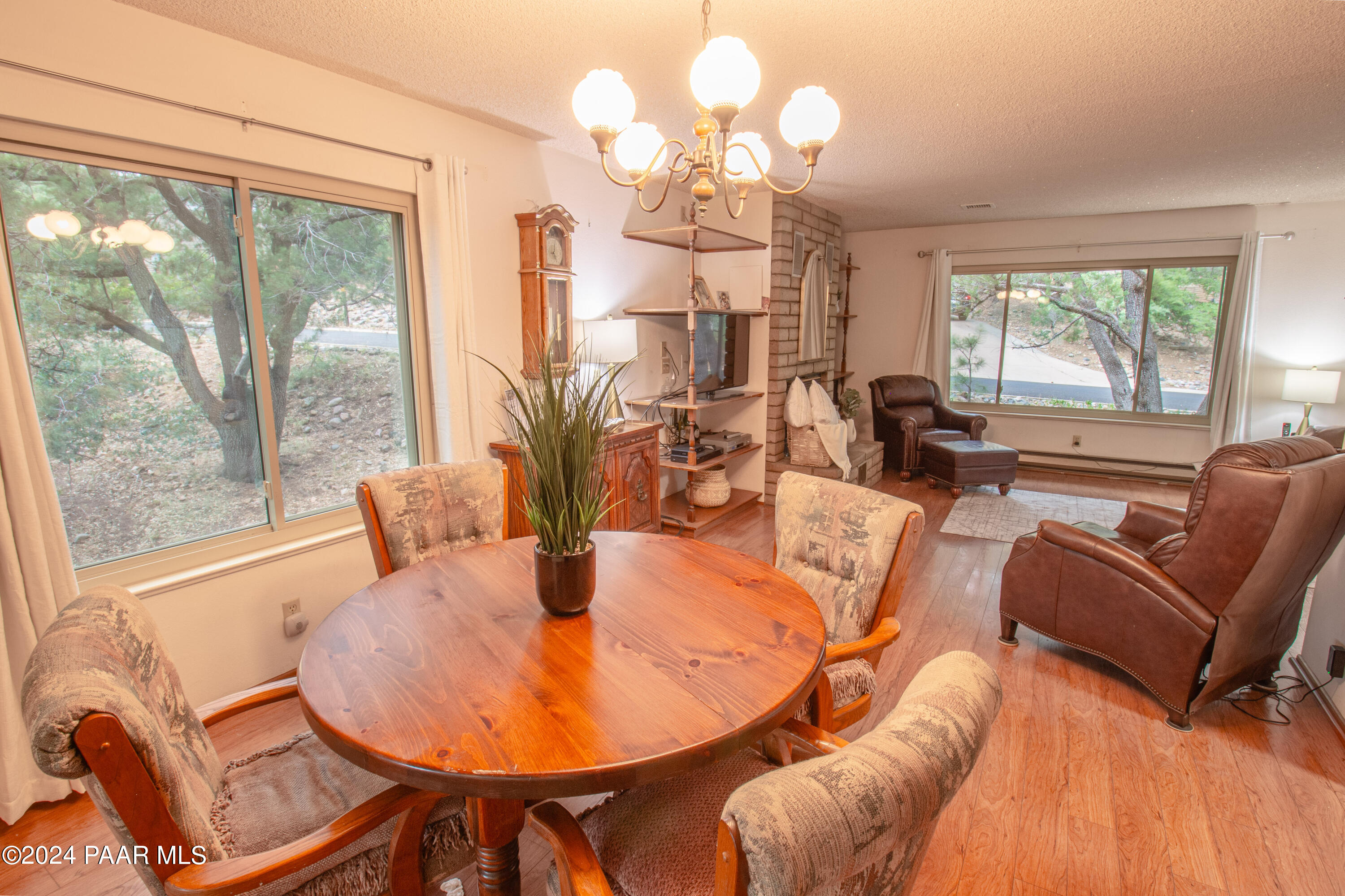 481 Turtleback Road Prescott, AZ 86303 - Photo 14 of 71 a living room with furniture a large window and a chandelier