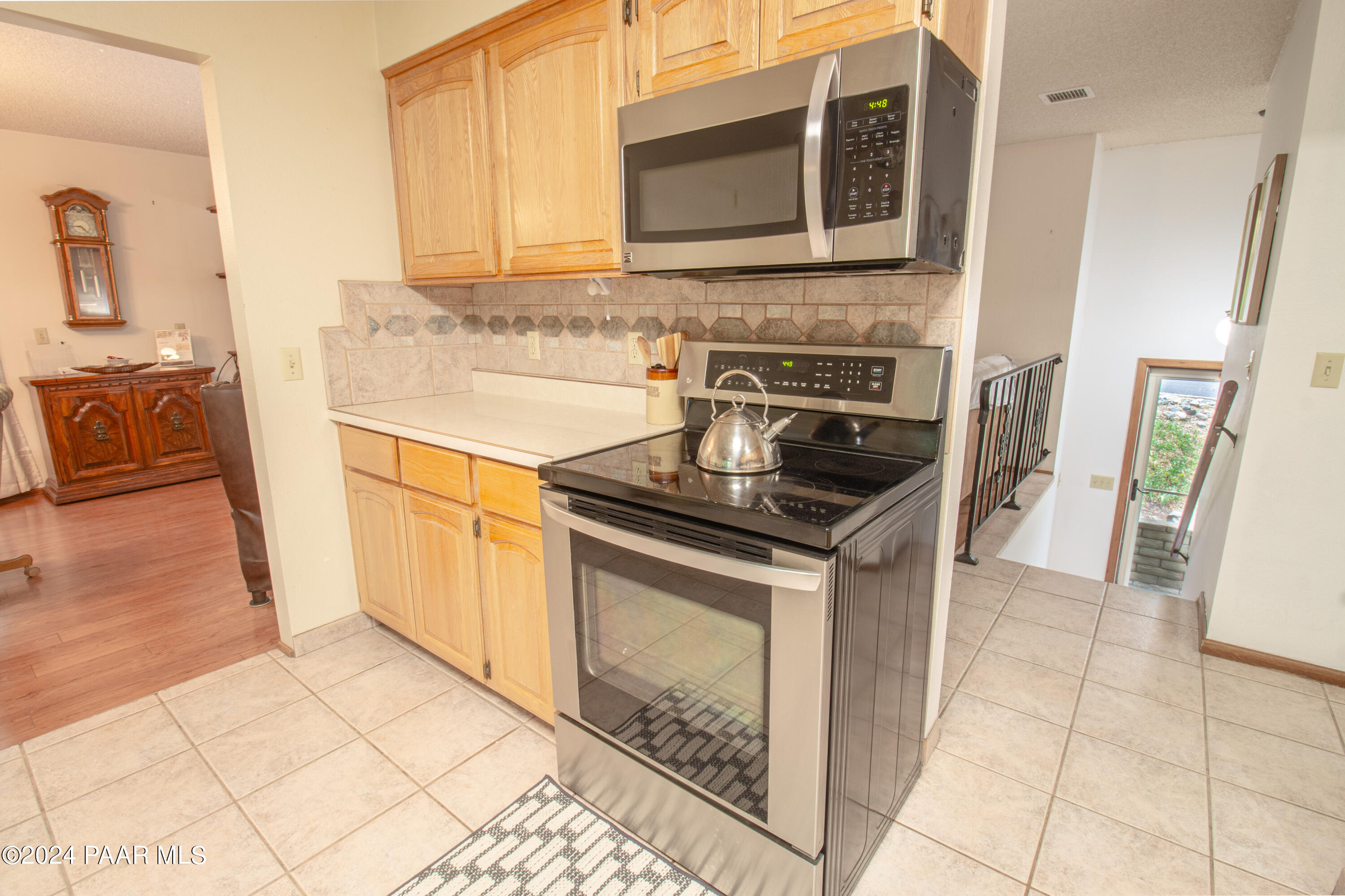 481 Turtleback Road Prescott, AZ 86303 - Photo 17 of 71 a kitchen with granite countertop a stove a sink and a microwave