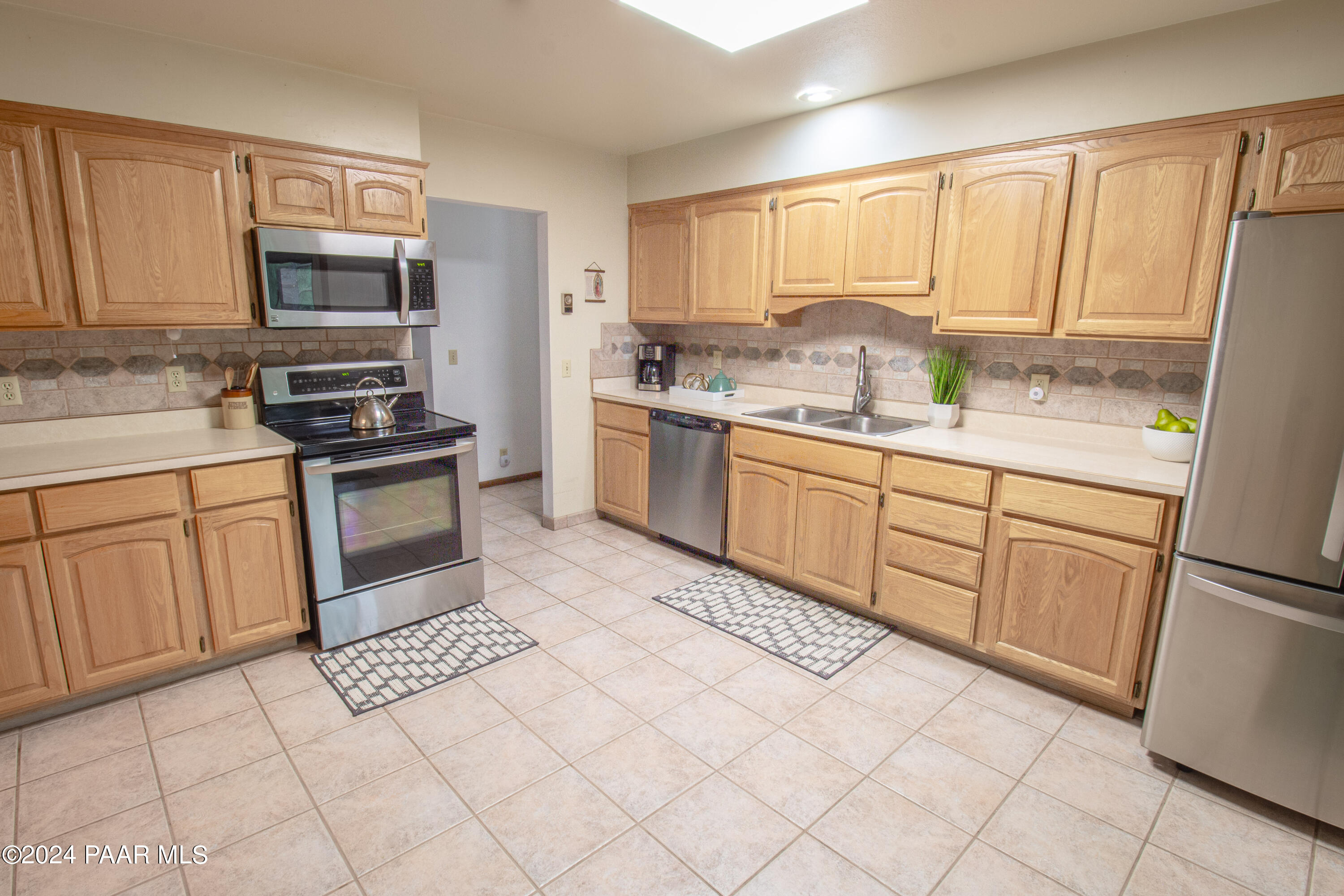 481 Turtleback Road Prescott, AZ 86303 - Photo 18 of 71 a kitchen with stainless steel appliances granite countertop a stove top oven a sink a counter space and cabinets