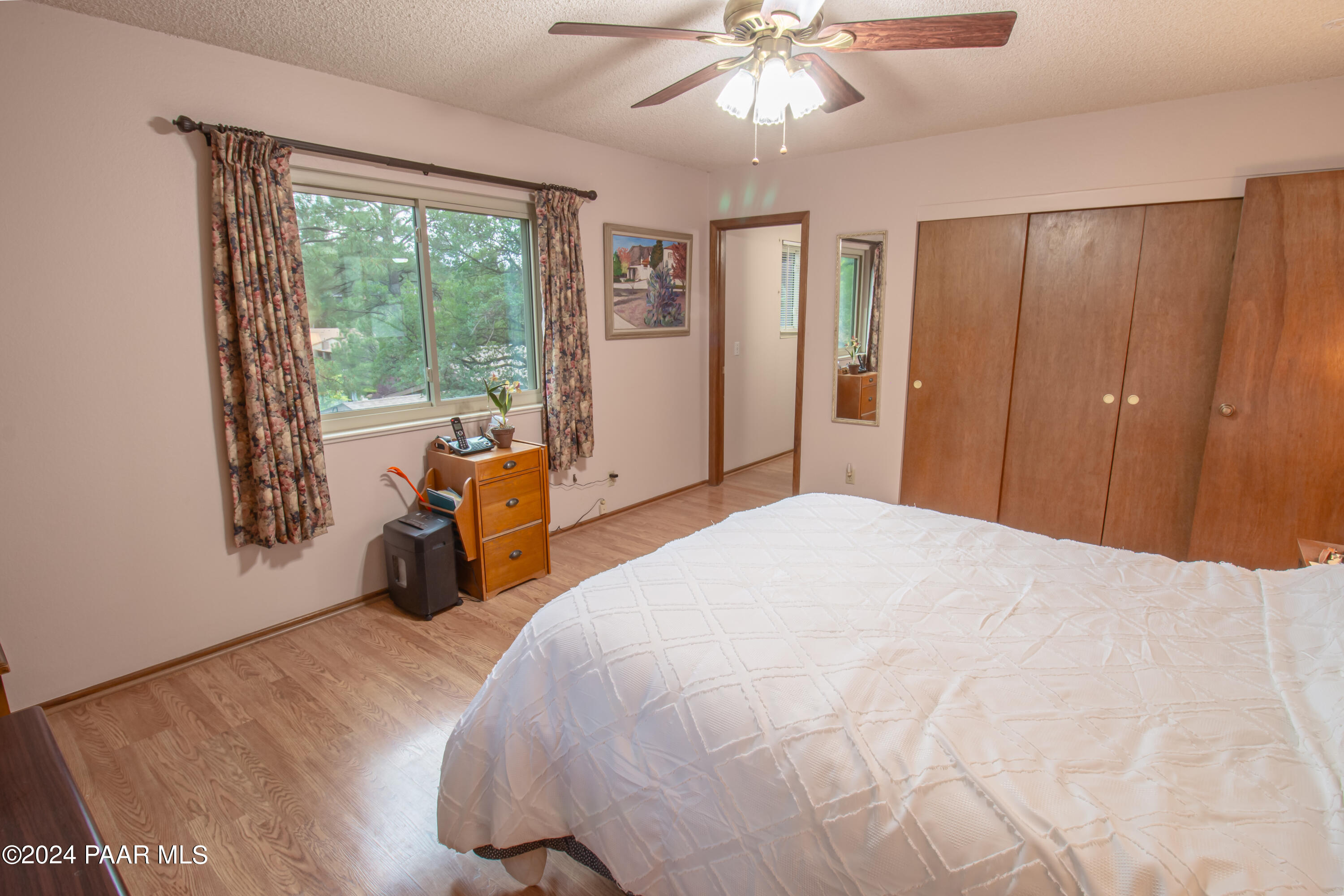 481 Turtleback Road Prescott, AZ 86303 - Photo 26 of 71 a bedroom with a bed and a chandelier