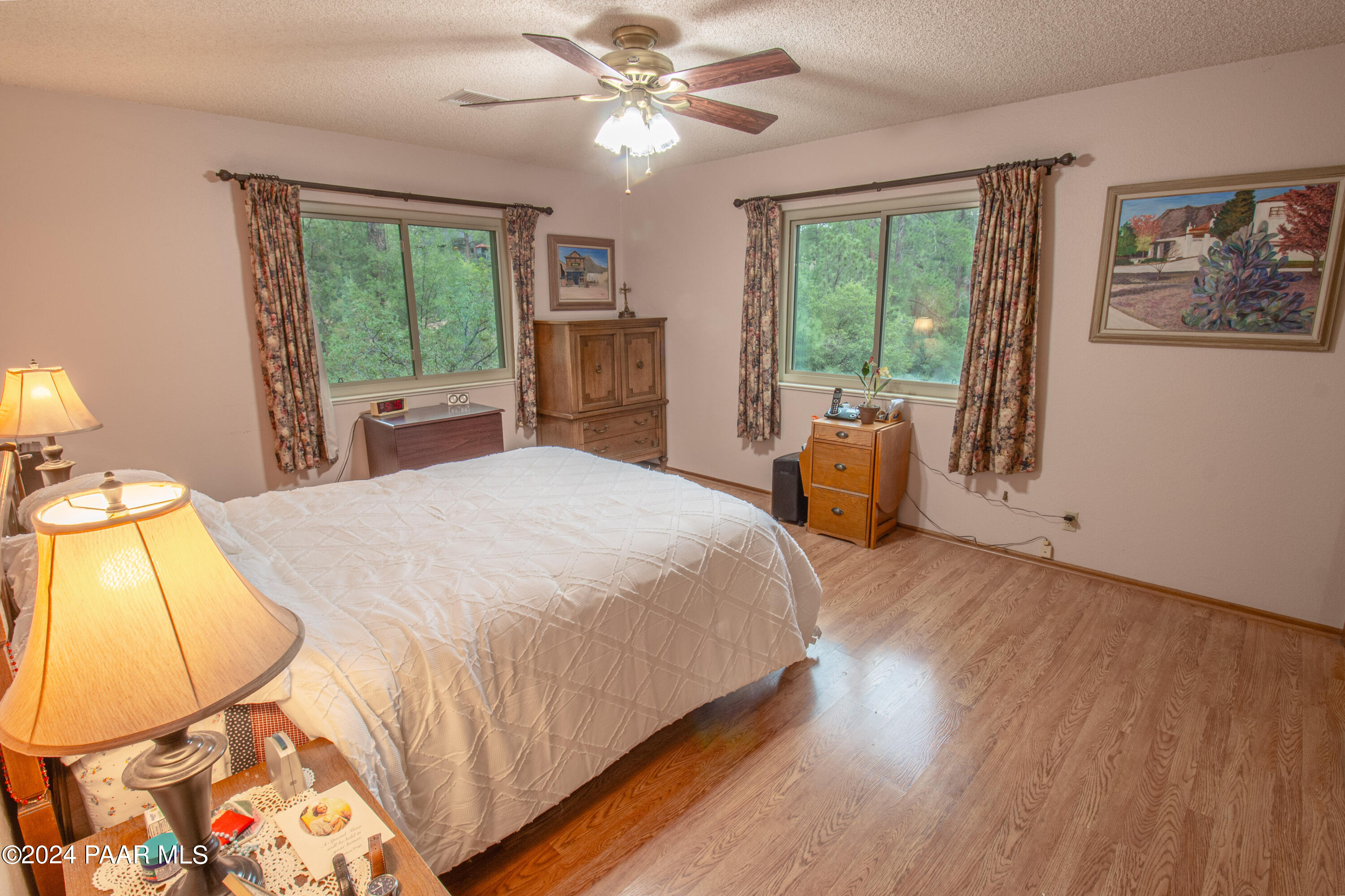 481 Turtleback Road Prescott, AZ 86303 - Photo 27 of 71 a bedroom with a large bed and a chandelier