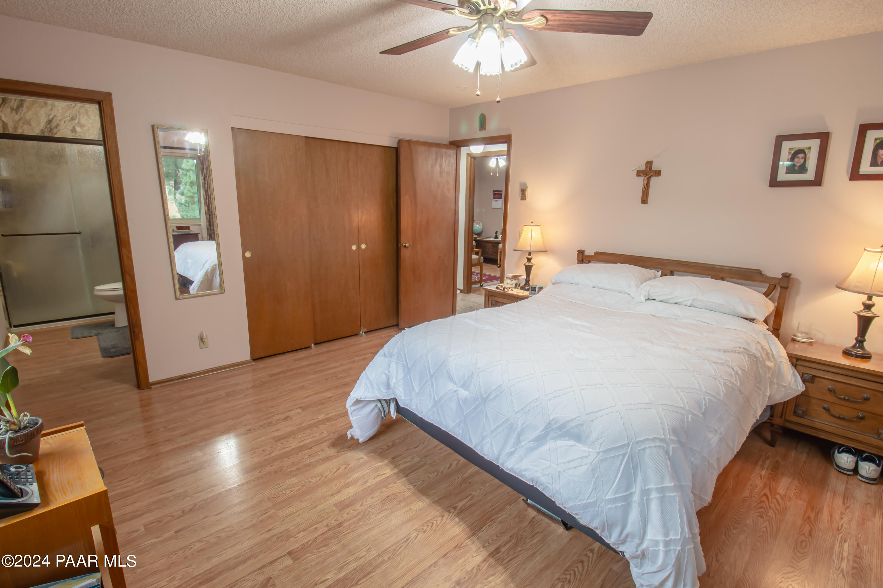 481 Turtleback Road Prescott, AZ 86303 - Photo 28 of 71 a spacious bedroom with a bed and a chandelier