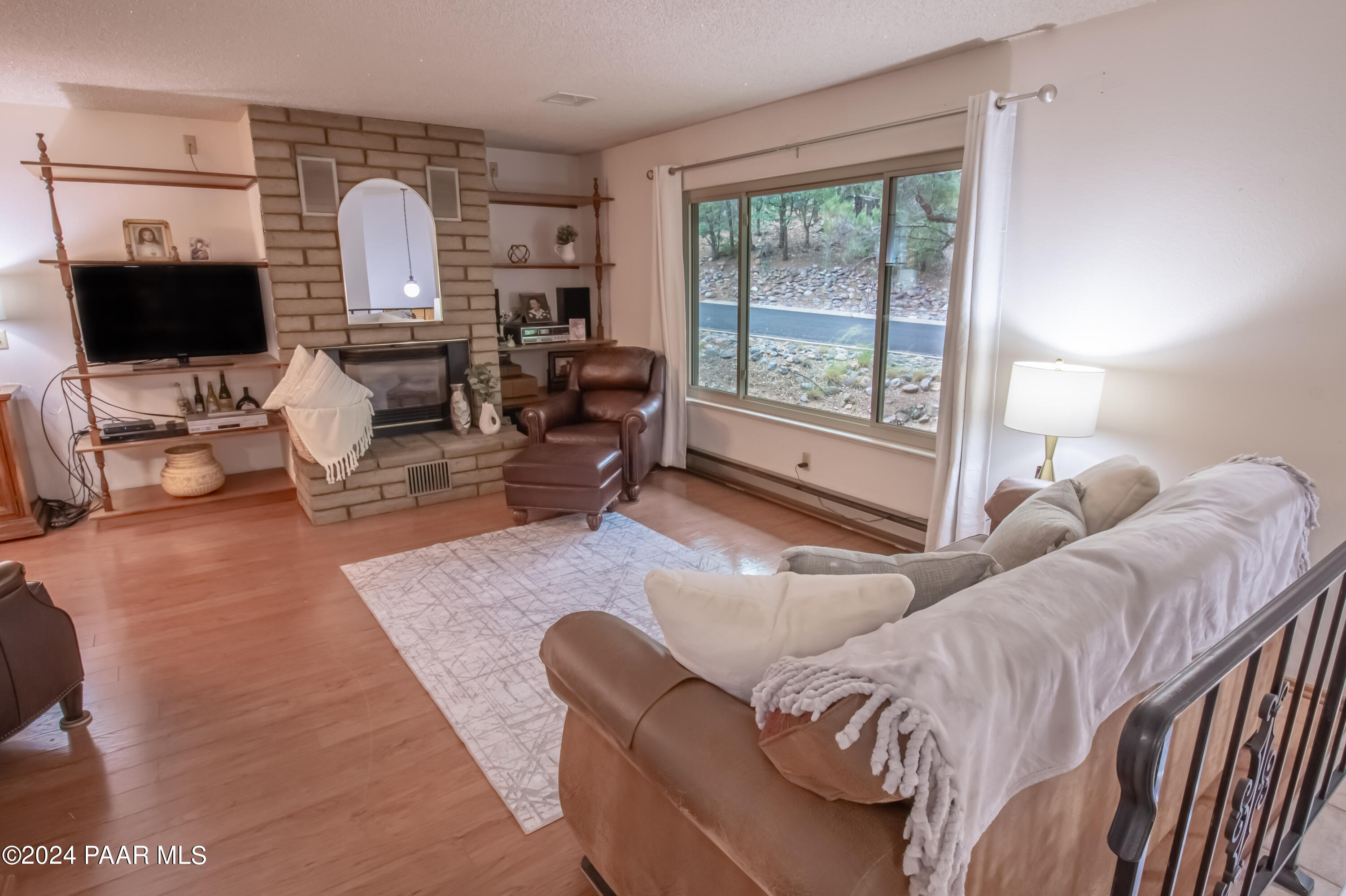 481 Turtleback Road Prescott, AZ 86303 - Photo 5 of 71 a living room with furniture a flat screen tv and a large window