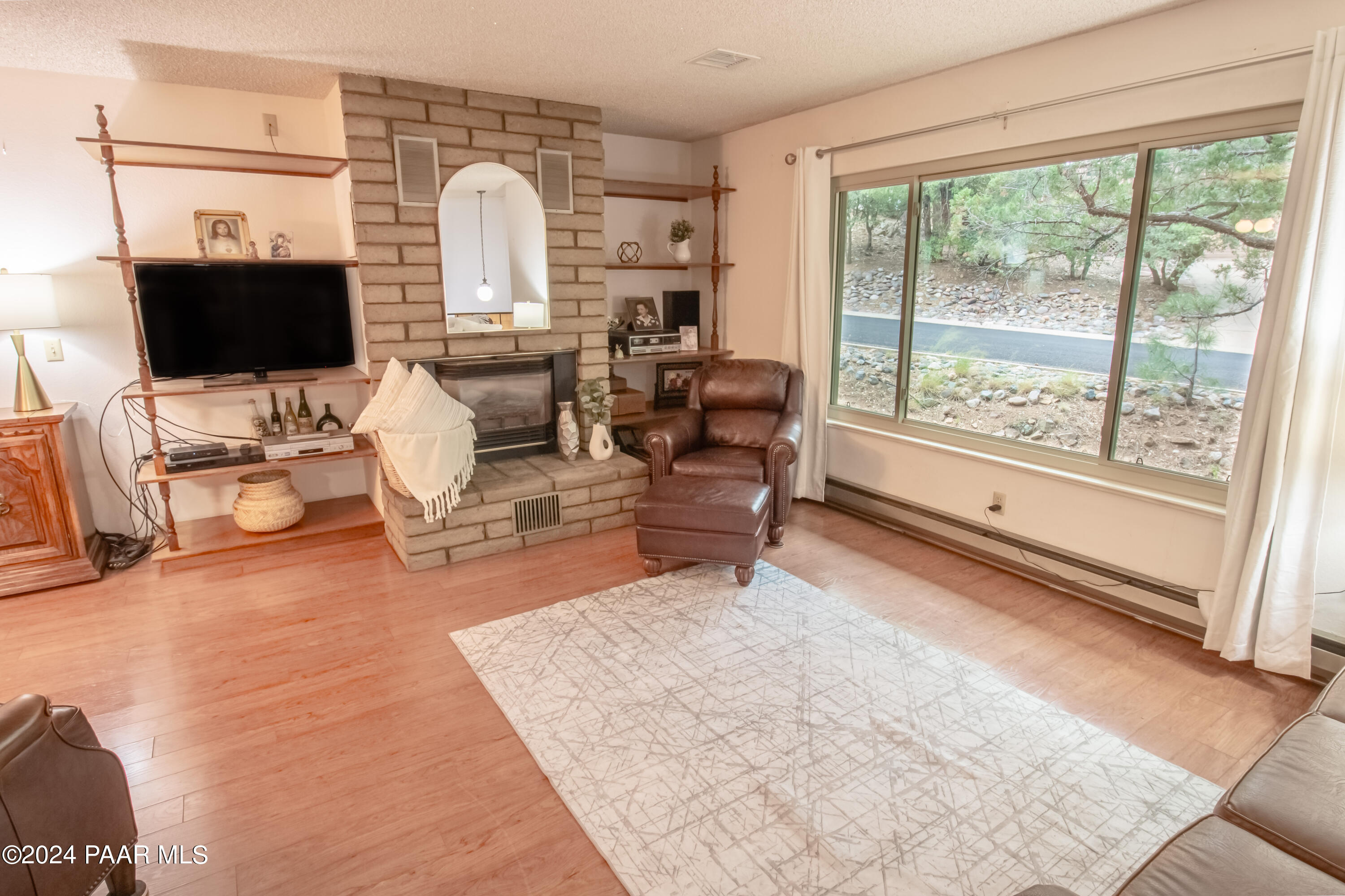 481 Turtleback Road Prescott, AZ 86303 - Photo 7 of 71 a living room with furniture fireplace and a flat screen tv