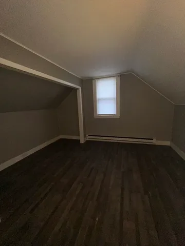 a view of a room with wooden floor and windows