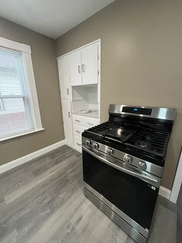 a stove top oven sitting inside of a kitchen