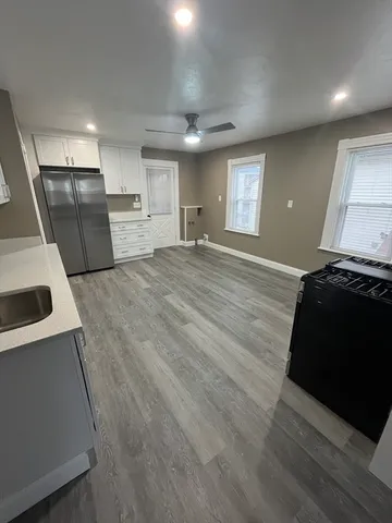 a view of a kitchen with a sink and a stove top oven