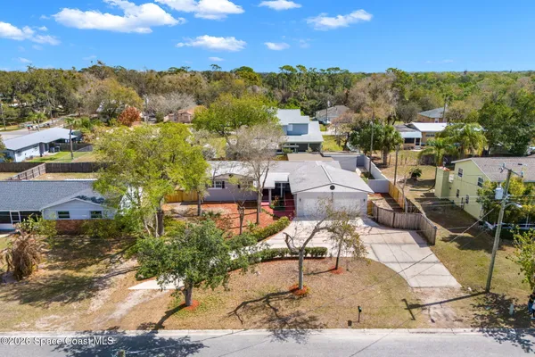 an aerial view of a house with a yard swimming pool and outdoor seating