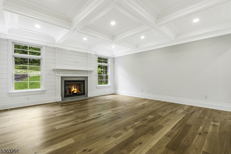 8 Cobblestone Court Warren, NJ 07059 - Photo 15 of 50 an empty room with wooden floor a fireplace and windows