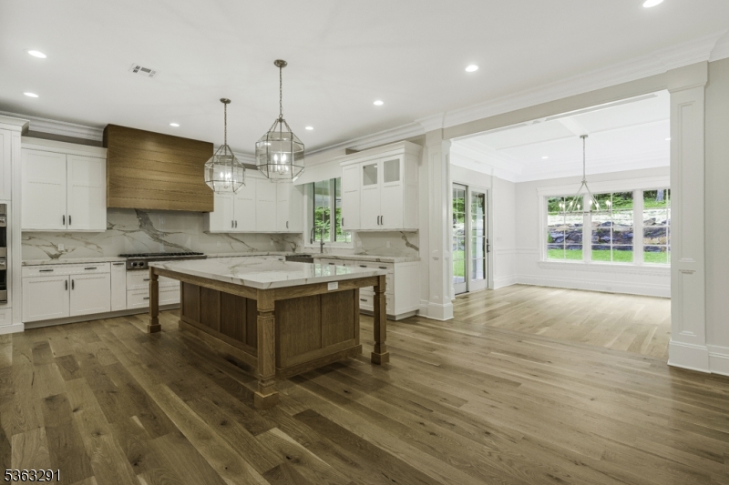 8 Cobblestone Court Warren, NJ 07059 - Photo 22 of 50 a kitchen with kitchen island granite countertop a stove and a sink