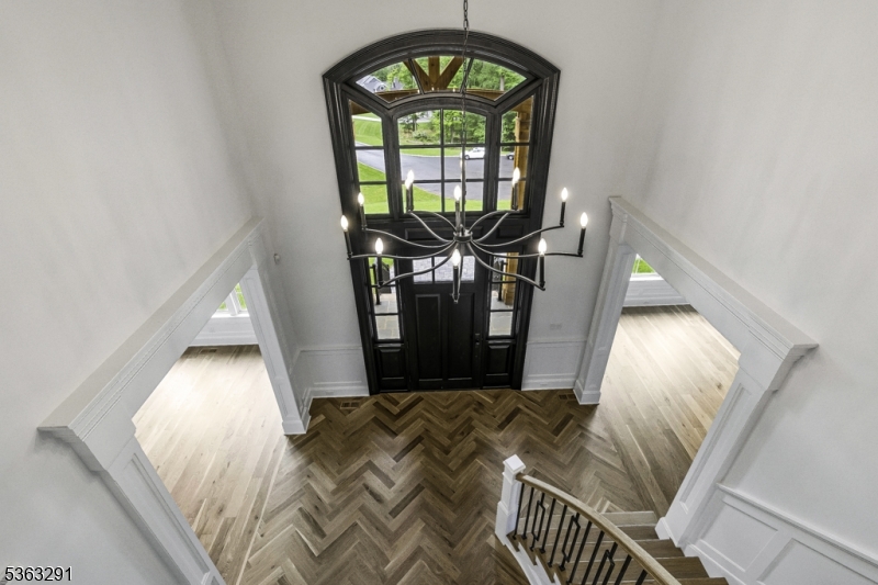 8 Cobblestone Court Warren, NJ 07059 - Photo 34 of 50 a view of a hallway with wooden floor and a chandelier