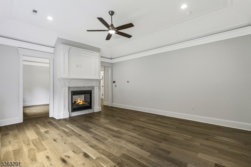 8 Cobblestone Court Warren, NJ 07059 - Photo 37 of 50 a view of a livingroom with a fireplace a ceiling fan and wooden floor