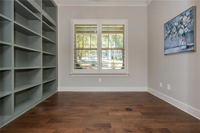 a large kitchen with stainless steel appliances kitchen island granite countertop a sink cabinets and wooden floor