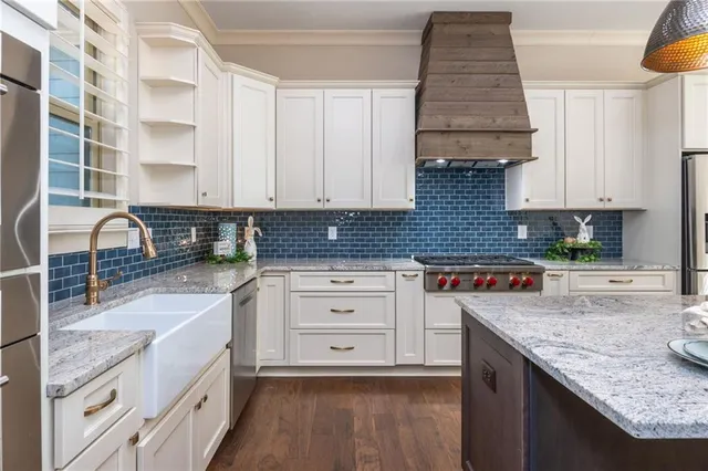 a kitchen with a table chairs and white cabinets