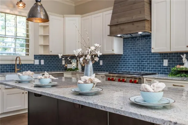 a kitchen with sink stove and cabinets